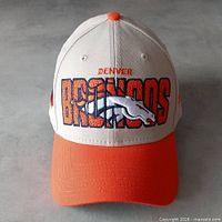 Front view of stone and orange New Era Denver Broncos fitted cap