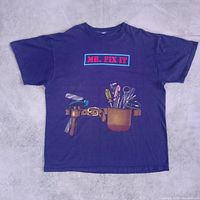 Front view of blue MR. FIX IT graphic T-shirt