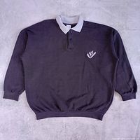 Full front view of sweater showing collar, placket, cuffs, waistband, and logo