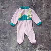 Full view of pink and teal baby romper laid flat