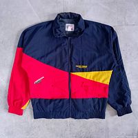 Front view of navy/red/yellow Toyo Tires windbreaker