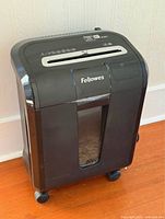 Front view showing Fellowes 84Ci shredder with bin window and casters