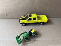 Yellow pickup and green tractor overview
