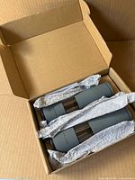 Mills in open cardboard box with protective wrap