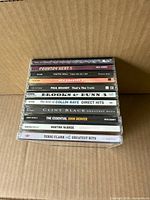 Stack of eleven CD jewel cases showing spines and titles
