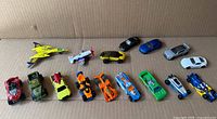 All 15 vehicles lined on cardboard