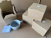Four individual cup boxes, one cup displayed with leaflet