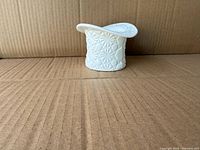 Front view of white milk glass top hat planter showing pattern