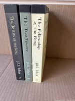 Spines of all three paperbacks standing