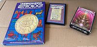 Group shot of all three items: astrology book, palmistry book, oracle card deck