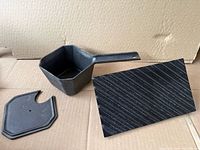 Small cast iron pour pot, lid, underside of grill press