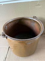 Top view of cylindrical copper pot showing interior patina