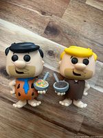 Front view of Fred and Barney figures showing details and accessories