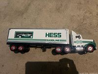 Left side view of Hess tractor trailer showing logo and racer inside