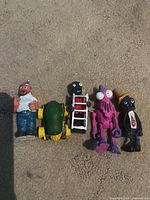 Front view of all five figures lined up on carpet
