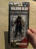 Front of sealed autographed Michonne action figure in blister packaging