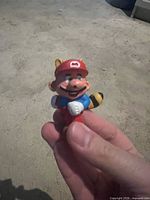 Front view of small Tanooki Mario plastic figurine