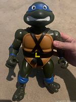 Front view of Leonardo action figure showing chest straps, blue bandana mask and overall condition