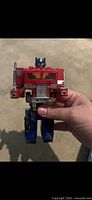 Front view of Optimus Prime figure showing colors, grille, Autobot logo