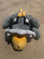 Top view of gray and yellow Dinobot plush showing overall shape and colors