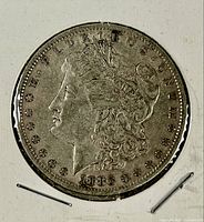 Obverse of 1883 Morgan silver dollar showing Liberty head and date