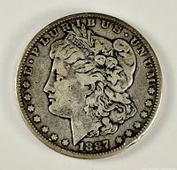 Obverse of 1887 Morgan silver dollar showing Liberty head and date