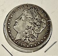 Obverse of 1899-O Morgan dollar showing date, Liberty profile, E Pluribus Unum