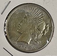 Obverse view of 1925 Peace silver dollar showing Liberty head, date, mottos