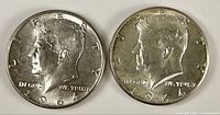 Obverse of both 1964 Kennedy Half Dollars showing date, portrait, mint mark placement