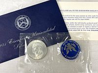 Blue Treasury envelope, coin and token sealed, information card visible