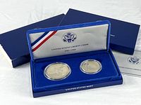 Closed blue velvet United States Mint presentation case with outer sleeve and insert