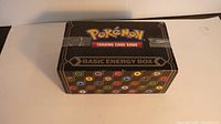 Front angled view of sealed Pokémon Basic Energy Box