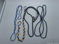 All four necklaces laid flat showing bead colours and styles
