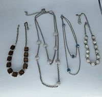 Overview of four necklaces laid out