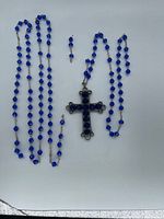 Full view of rosary laid flat showing bead strands and crucifix