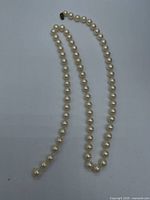 Full strand laid flat showing pearls and missing clasp