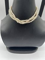 Front view of triple-strand faux pearl choker displayed on bust