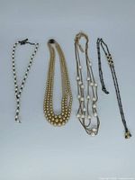 All four necklaces laid flat for overview
