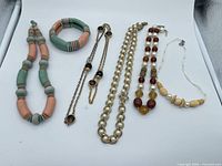 All seven jewelry pieces laid out for overview