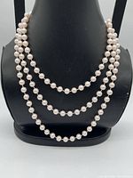 Necklace doubled on display bust showing pearl size and colour