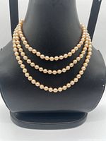 Necklace displayed coiled thrice on bust to show bead uniformity and color