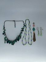 Overview of all five jewelry items laid flat