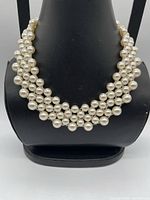 Front view of four-row faux pearl collar on display bust