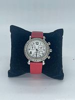 Front view of La Swiss chronograph watch on pillow