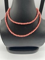 Necklace displayed on bust form showing bead uniformity and color