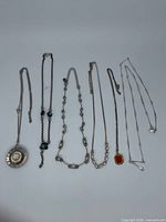 Six necklaces laid out side by side