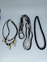 Three necklaces side by side showing overall designs and colours