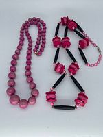 Both necklaces laid flat showing bead styles and colors