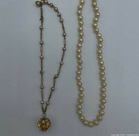 Both necklaces laid flat showing full length and pendant detail