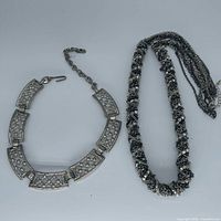 Both necklaces laid flat showing overall designs